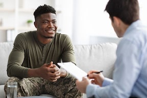 Doctor of Audiology Counseling a Patient About the Tinnitus Treatment Options